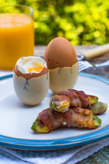 Soft-boiled eggs with pancetta avocado soldiers
