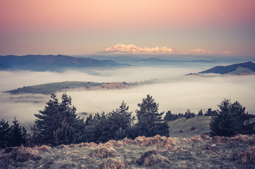 panorama over misty Spisz highland to snowy Tatra mountains in the morning, Poland landscape