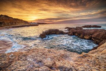 Algarve, Portugal: rocks in the coast of Albufeira at sunrise
