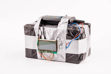 bomb with screen, cell phone and colored wires on a white background. Terrorism and military concept