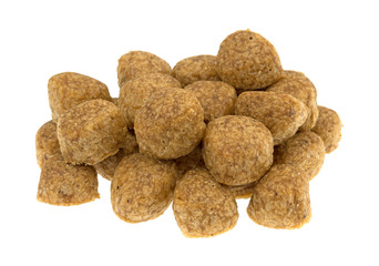 Large pile of chicken meatball dog food isolated on a white background.