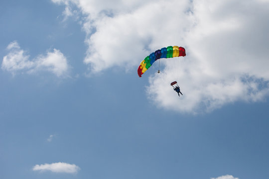 skydivers parachutist on blue sky on sunset