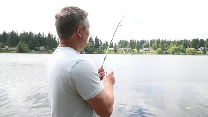 Fisherman reeling in a fish