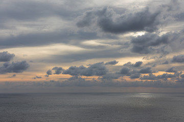 A sunset on a gray sky over the sea