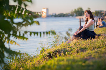 Naklejka na ściany i meble young woman on the river bank