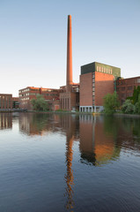 Obraz premium Tampere city old industrial buildings in Tammerkoski river, Finland.