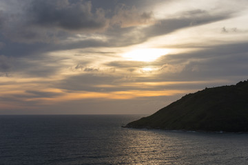 Naklejka na ściany i meble Sunset at sea and part of the island