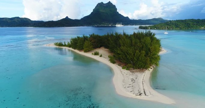 Bora Bora in French Polynesia. Aerial view of Motu paradise island and turquoise blue water in coral reef lagoon and Mt Pahia, Mount Otemanu, Tahiti, South Pacific Ocean.