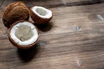 tropical fruits with broken coconut on wooden background space for text