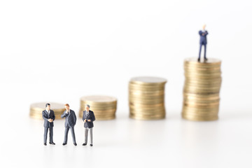 miniature model group of businesspeople standing together with coin isolated on white background.