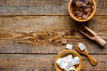 variety of sugar in bowls on wooden table background top view space for text