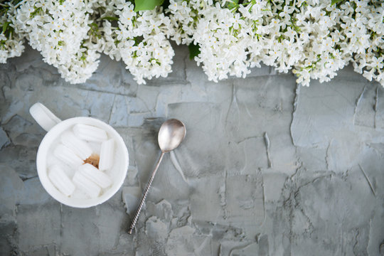 Cup of coffee with marmelo white lilac