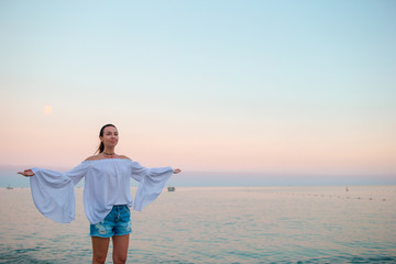 Young woman enjoying vacation on the beach in Europe