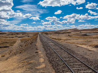 Train railroad under clouds in the sky