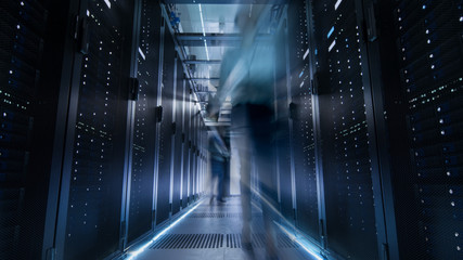 Shot of Corridor in Large Data Center Full of Moving and Working People. Pronounced Motion Blur.