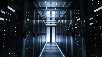 Shot of a Corridor in Large Working Data Center Full of Rack Servers and Supercomputers.