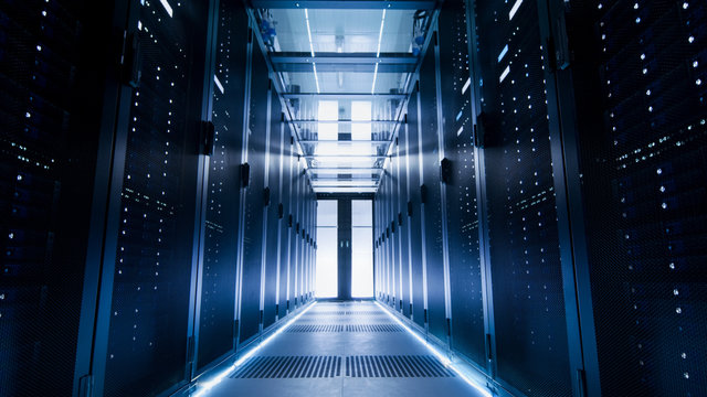 Shot of a Corridor in Large Working Data Center Full of Rack Servers and Supercomputers.