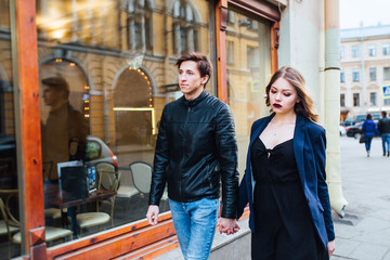 Cheerful couple walking through the city together