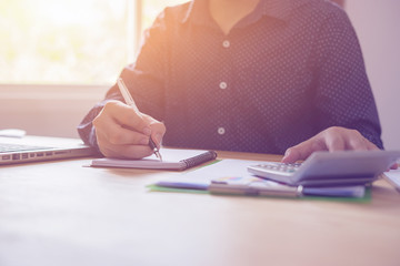 finance,accounting,Businessman analyzing investment charts with calculator laptop calculate technology in office,business, concept,selective focus,vintage color