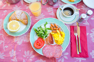 Tasty traditional appetizing yummy breakfast at the restaraunt outdoors. Fresh coffee and croissant