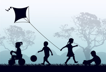 Silhouettes of children playing outside in the grass and trees