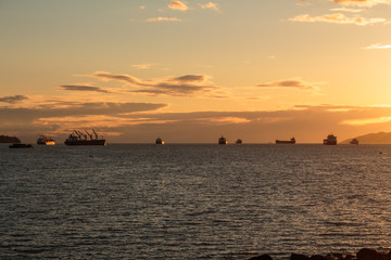 Fototapeta na wymiar Photo of cargo boats on sunset at English Bay, Vancouver, BC
