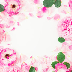 Obraz premium Round floral frame of pink ranunculus flowers, roses, petals and leaves on white background. Floral lifestyle composition. Flat lay, top view.