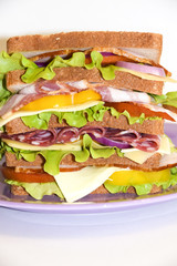 Tall sandwich violet plate beef pork tomato white background