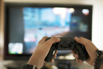hands with joystick and tv © carballo