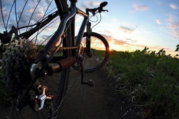 Obraz na płótnie Canvas bike close-up on the trail at sunset.