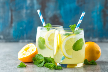 Lemonade or mojito cocktail with lemon and mint, cold refreshing drink or beverage with ice. - 160957140