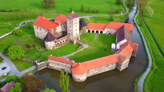 Aerial view of Svihov castle from 14th century. Gothic water castle in National Park Sumava. Drone camera flying over cultural monument of the Czech Republic, European union. 