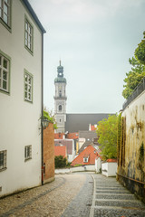 A view of St Georges Church belfry above the city roofs in Freising, Germany.