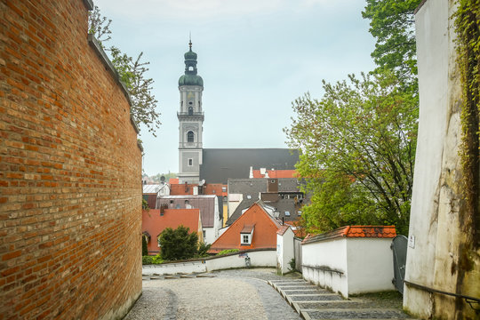 A view of St Georges Church belfry above the city roofs in Freising, Germany.