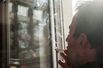 Man smoking a cigar, halfprofile, smoke cigars accented