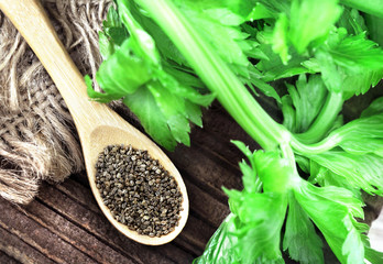 Celery seeds in spoon on wooden background, selective focus - obrazy, fototapety, plakaty