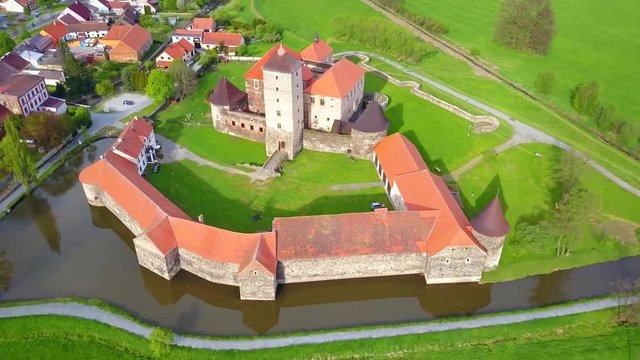 Aerial view of Svihov castle from 14th century. Gothic water castle in National Park Sumava. Drone camera flying over cultural monument of the Czech Republic, European union. 