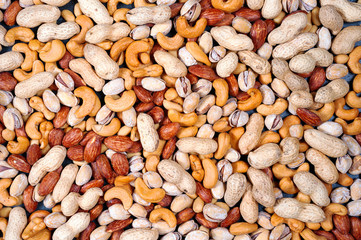 mix almonds, cashew nuts, hazelnut, peanuts, walnuts, pistachio on wood background