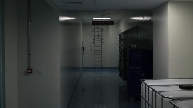 Camera creeps along industrial laboratory corridor