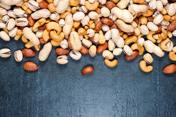 Healthy Mix Nuts on dark background. Almonds, Pistachio, Cashews