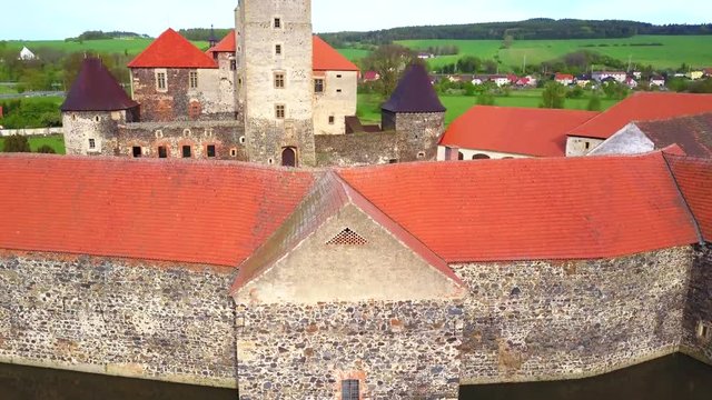 Aerial view of Svihov castle from 14th century. Gothic water castle in National Park Sumava. Drone camera flying over cultural monument of the Czech Republic, European union. 