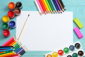 school and office supplies. school background. colored pencils, pen, pains, paper for  school and student education on blue wood background. top view with copy space