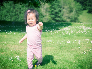 baby girl playing in summer garden