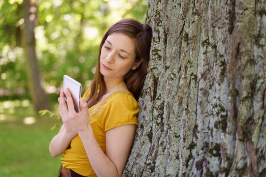 Serious young woman reading a text message