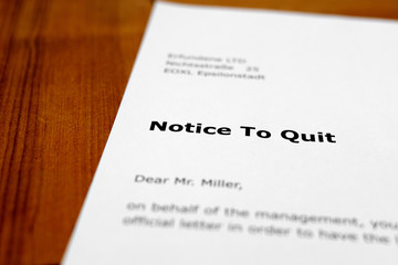 A letter on a wooden table - notice to quit