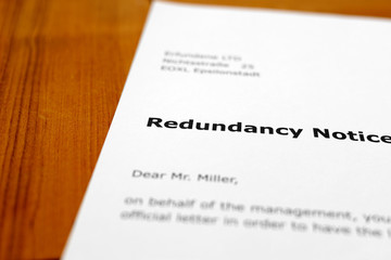 A letter on a wooden table - redundancy notice