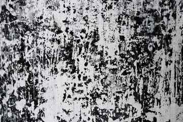 Abstract textured background in black and white, the base of the concrete electric pole whitewashed with lime