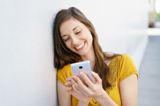 happy young woman reading a text message