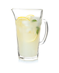 Tasty refreshing lemonade in glass jug on white background