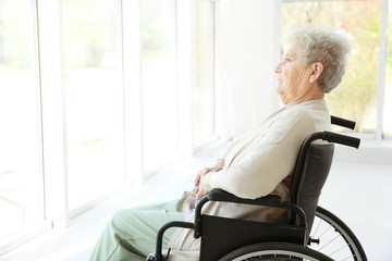 Fototapeta na wymiar Disabled elderly woman in wheelchair at home